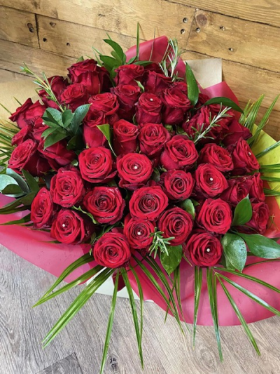 50 Red Roses - Let us create the WOW factor for you with 50 beautiful red roses in an aqua pack with romantic wrapping and diamantes throughout.