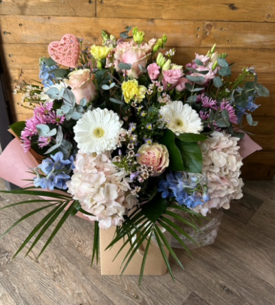 Pastel WOW Bouquet - This will be a beautiful bouquet created by one of our talented florists and include a mix of fresh pastel seasonal flowers with a variety of foliage to compliment the bouquet. This will be presented in our boxes with food and water for longer lasting stems. Our aim will be to use similar colours and flowers as shown in the picture, but it depends on availability. If you would like a different amount to prices shown, please amend the payment box. Size shown is standard.