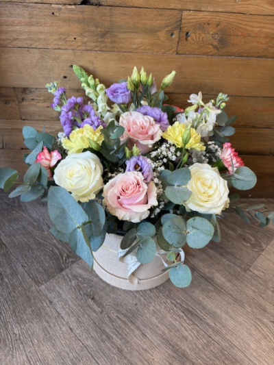 Pastel Hat Box - A beautiful pastel hat box arrangement using a variety of softer tones. Flowers may vary depending on availability. Size shown is medium