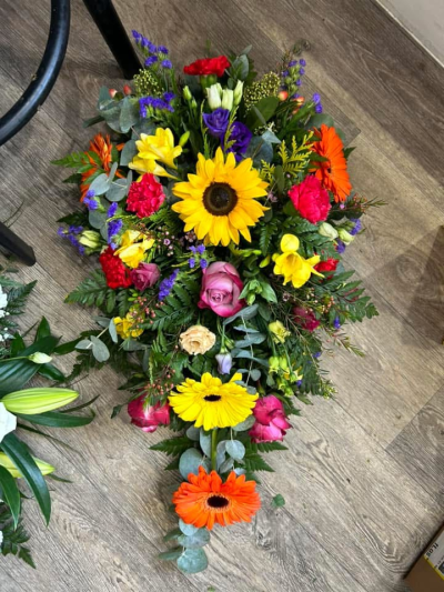Multi Coloured Single Ended Spray - This would be a single ended spray tribute created with a mix of vibrant colours. Exact flowers used may vary depending on availability although the style will be as close to the picture as possible.