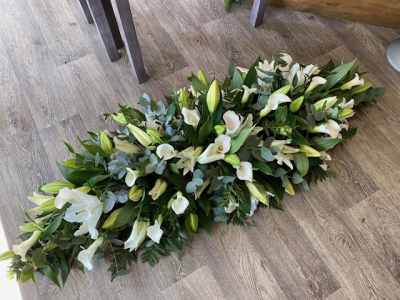 Cream and Green Lily Double Ended Spray - This would be a cream and green themed double ended spray using white lilies and calla lilies. 
Size shown is a full size coffin top spray (size large)
